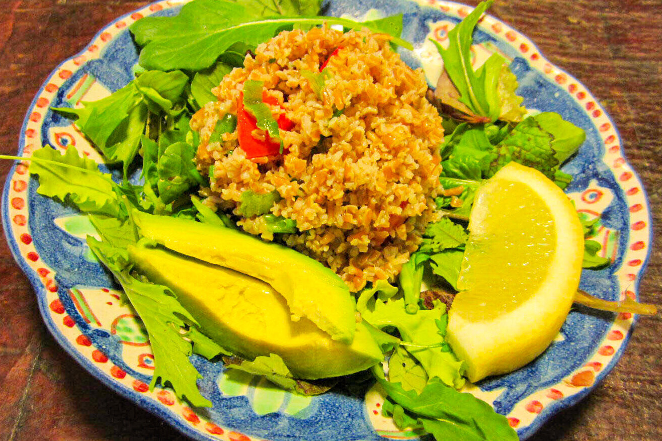 Tabouli served on a bed of lettuce with avocado and lemon