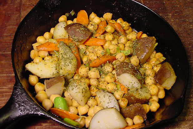 curried garbanzo beans with potatoes in a cast iron pan