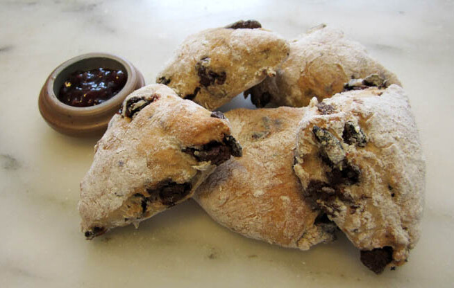 Five cranberry chocolate scones with a side of jam