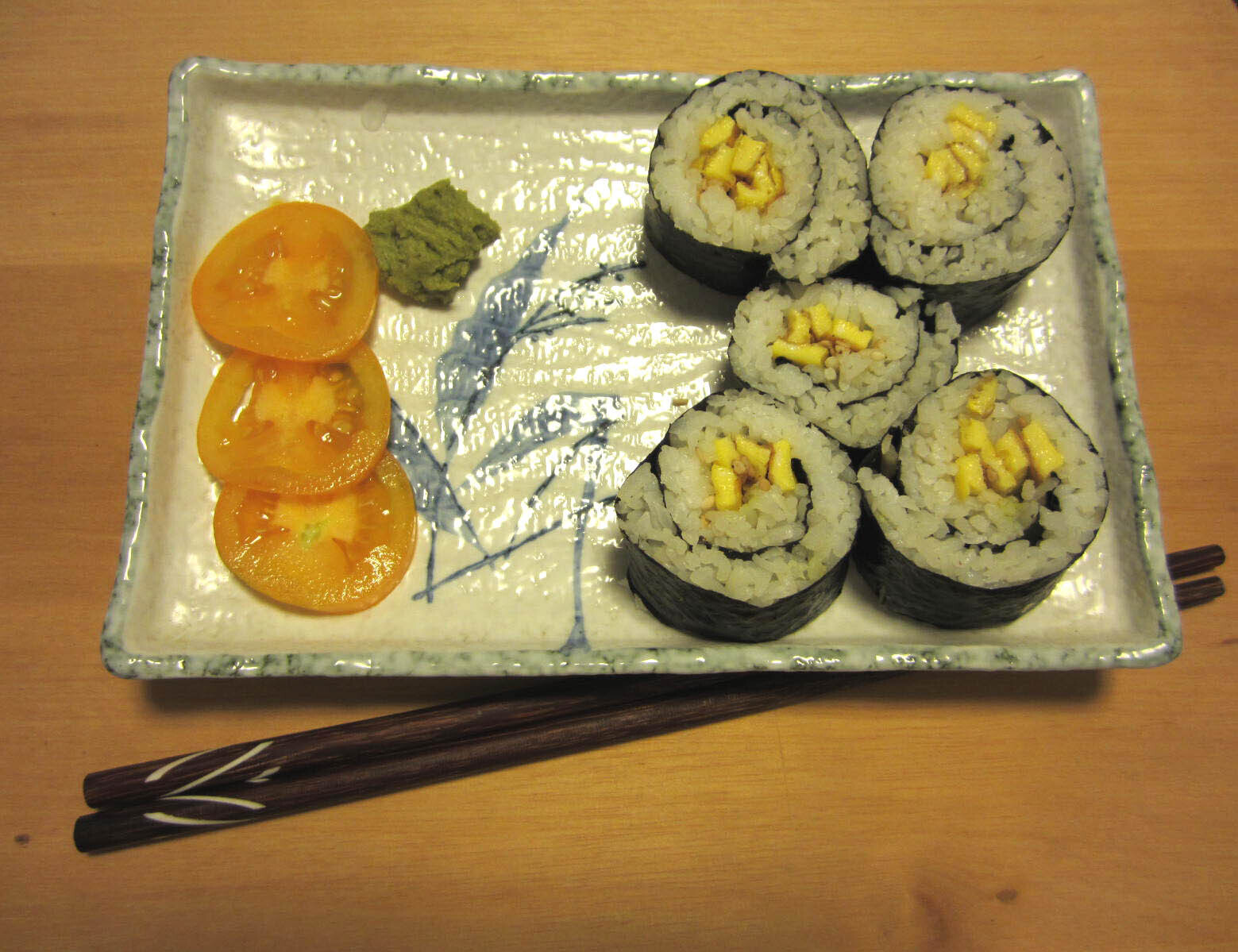 Egg sesame nori sushi rolls with a side of tomato and Wasabi
