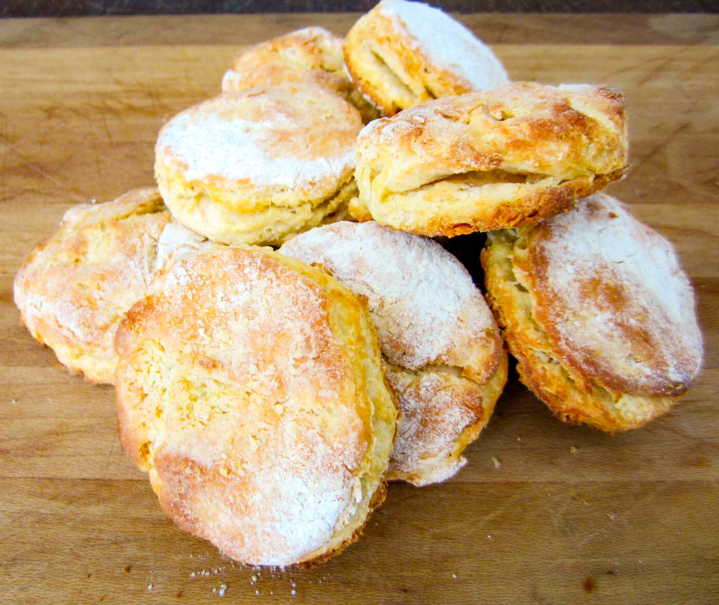 cooked biscuits in a pile on a wooden board