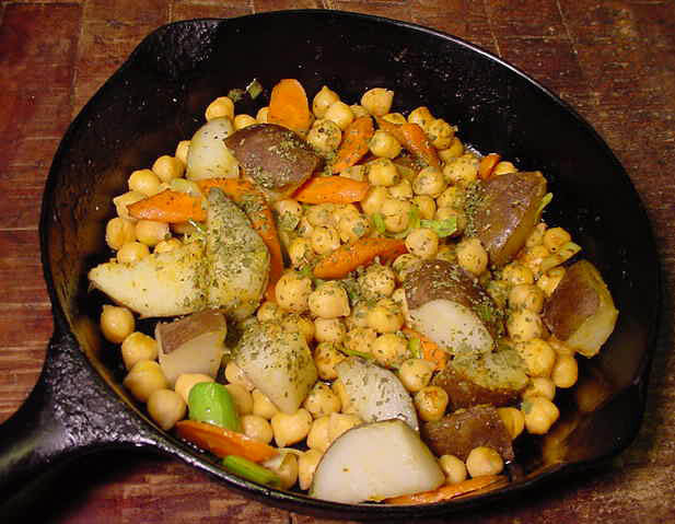 curried garbanzo beans with potatoes in a cast iron pan