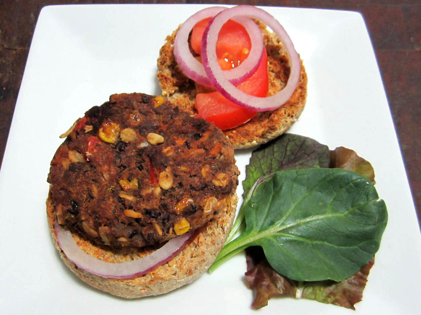 Black bean burgers with red onion, tomato, and lettuce